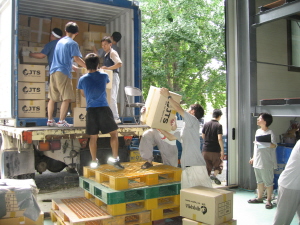 Volunteers loading containers with N. Korea flood relief items